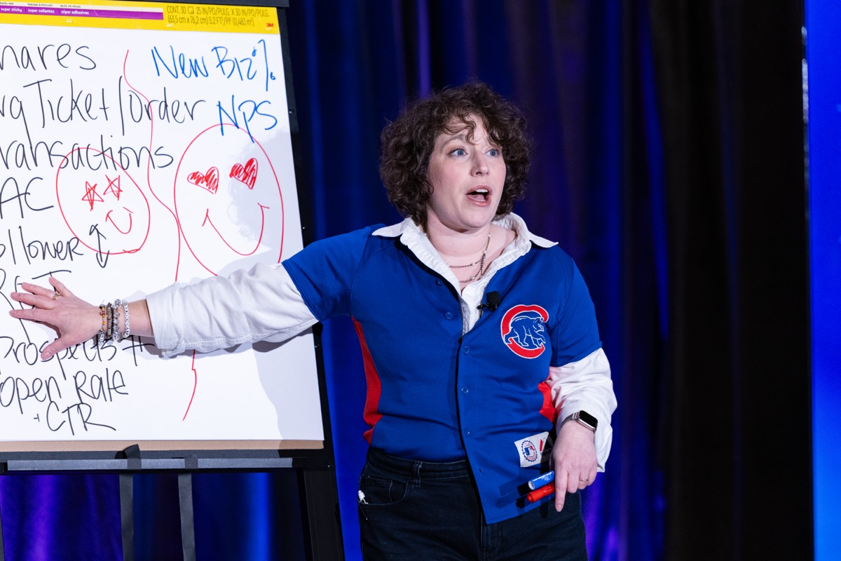 Lauren Teague, wearing a Chicago Cubs jacket, leading a live whiteboard exercise at Digital Summit Chicago